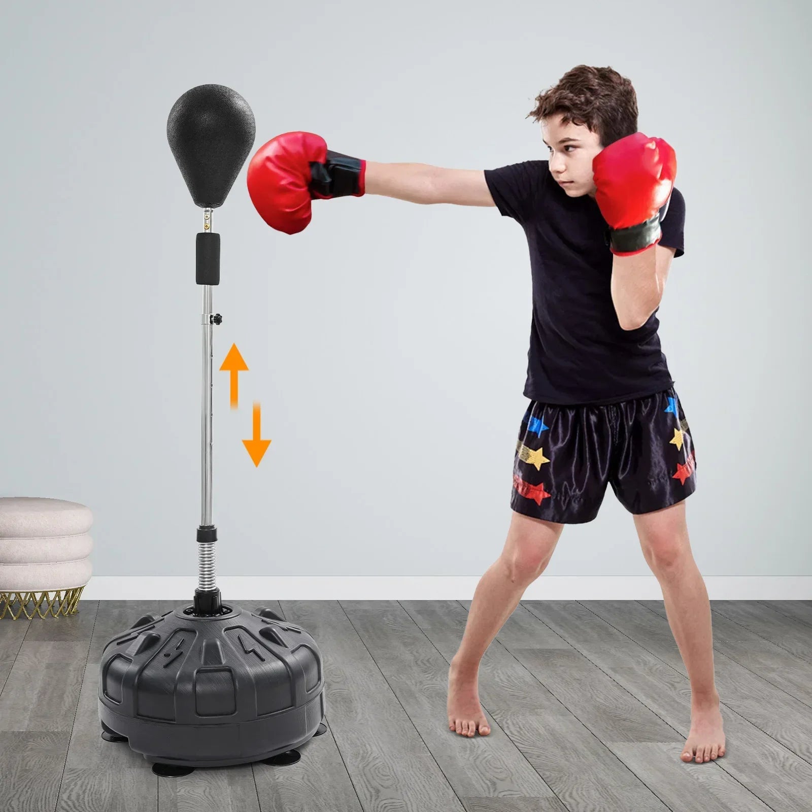 Free-standing adjustable punching bag with rebound spring